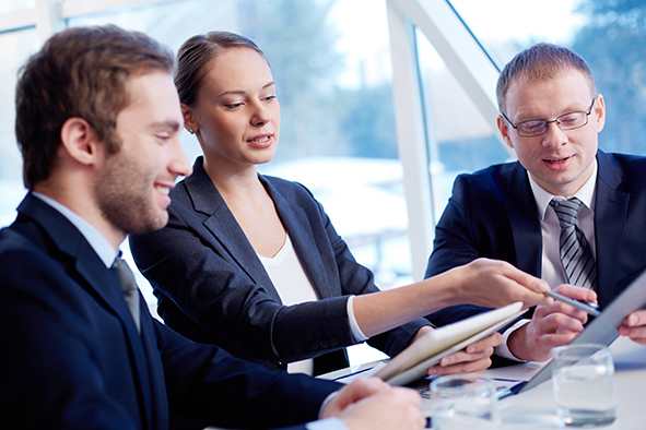 stock-photo-group-of-confident-business-partners-discussing-paper-at-meeting-130378301