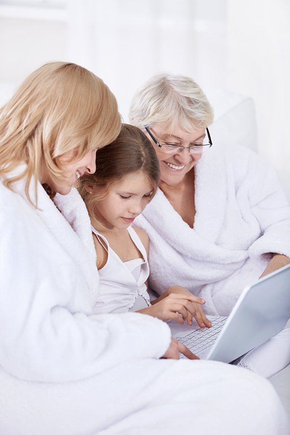 stock-photo-grandmother-mother-and-daughter-with-laptop-68716357